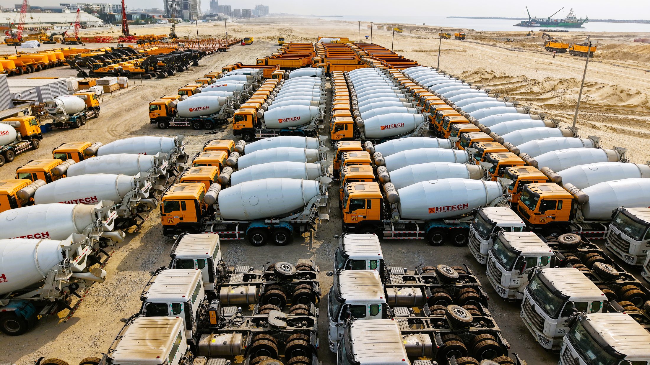 Hitech concrete mixer trucks arranged in rows at the plant yard