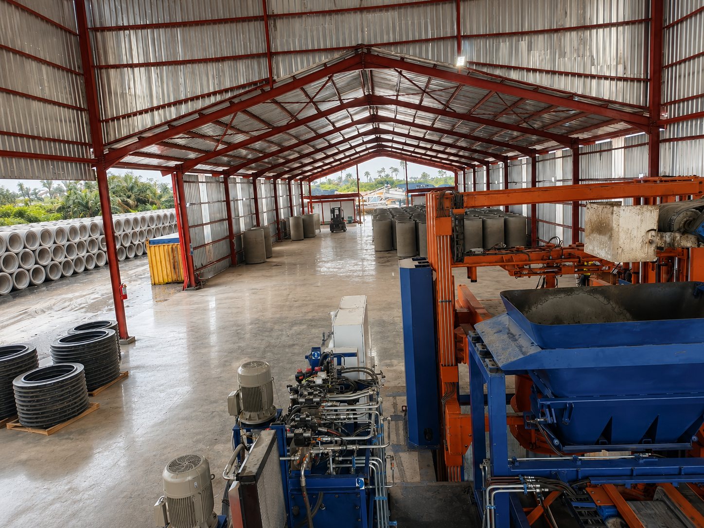 Concrete pipe production facility with finished pipe sections inside the factory
