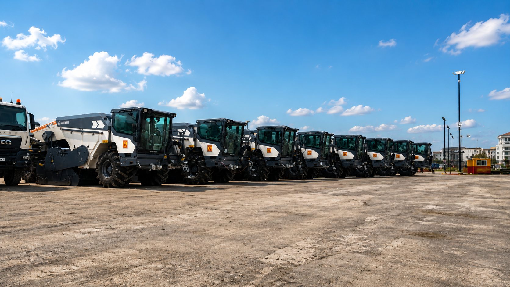 Low-angle view of Wirtgen soil stabilizers lined up at the equipment yard
