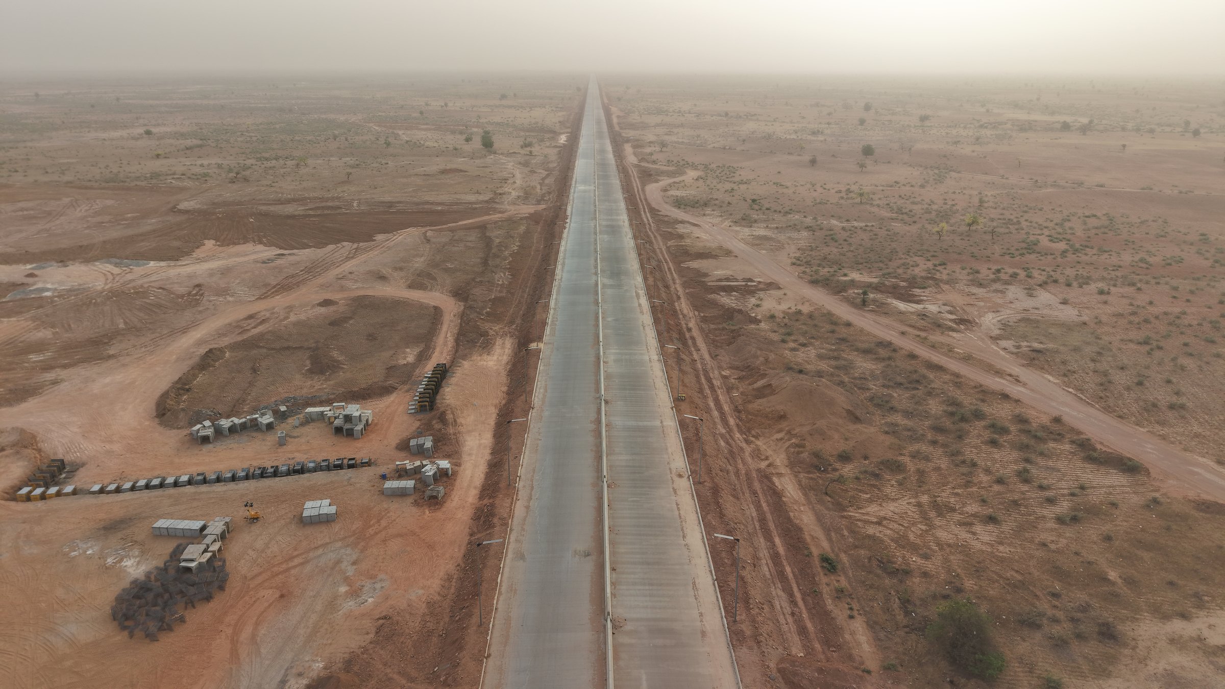 Long concrete roadway extending through the Kebbi landscape
