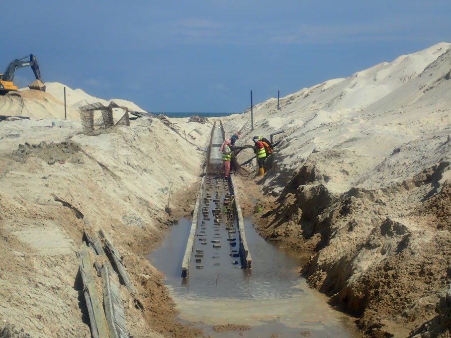 Irrigation channel works progressing inside an excavated corridor